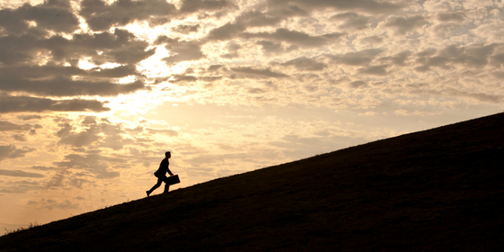 Man walking uphill - LEAD Program leadership training course